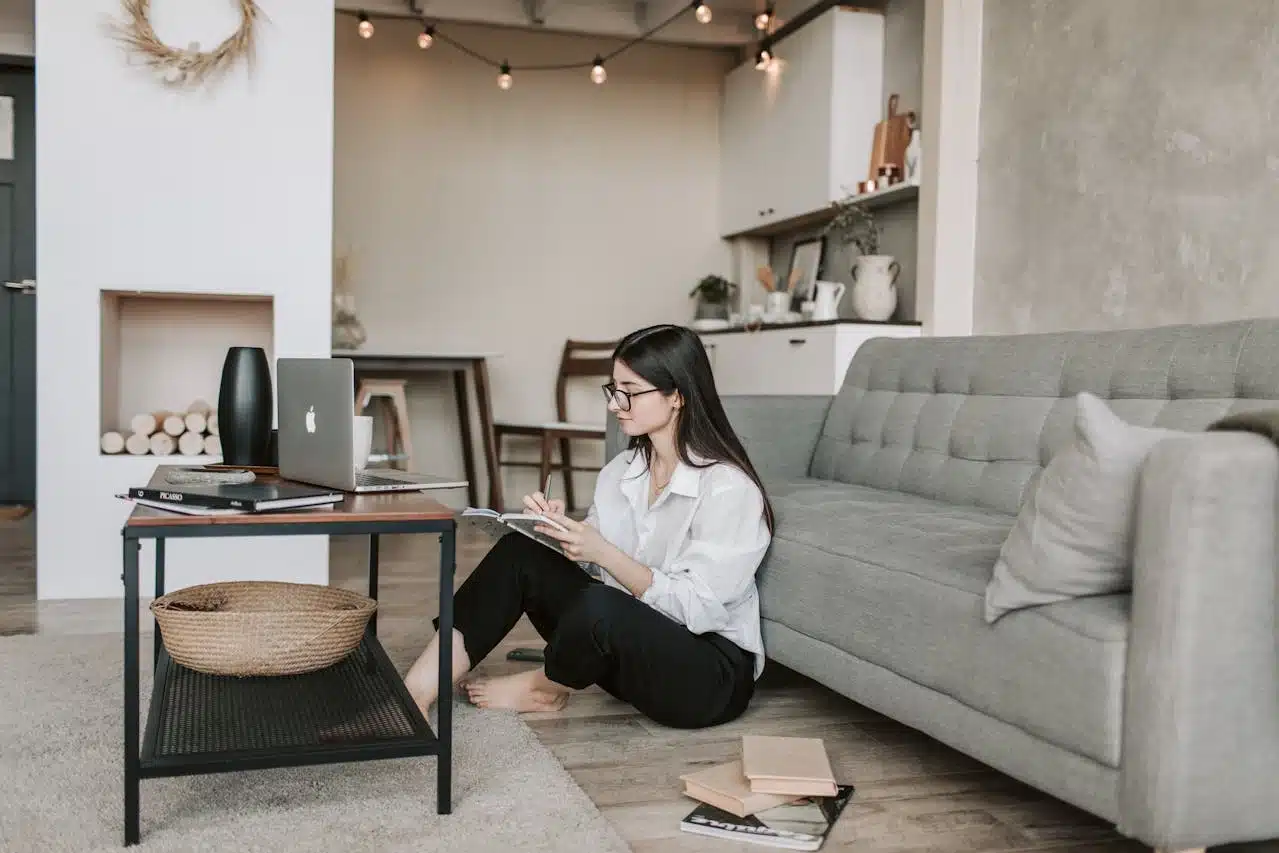 a freelancer working on laptop as well as writing Legit-Platforms-to-Find-Remote-Writing-Jobs