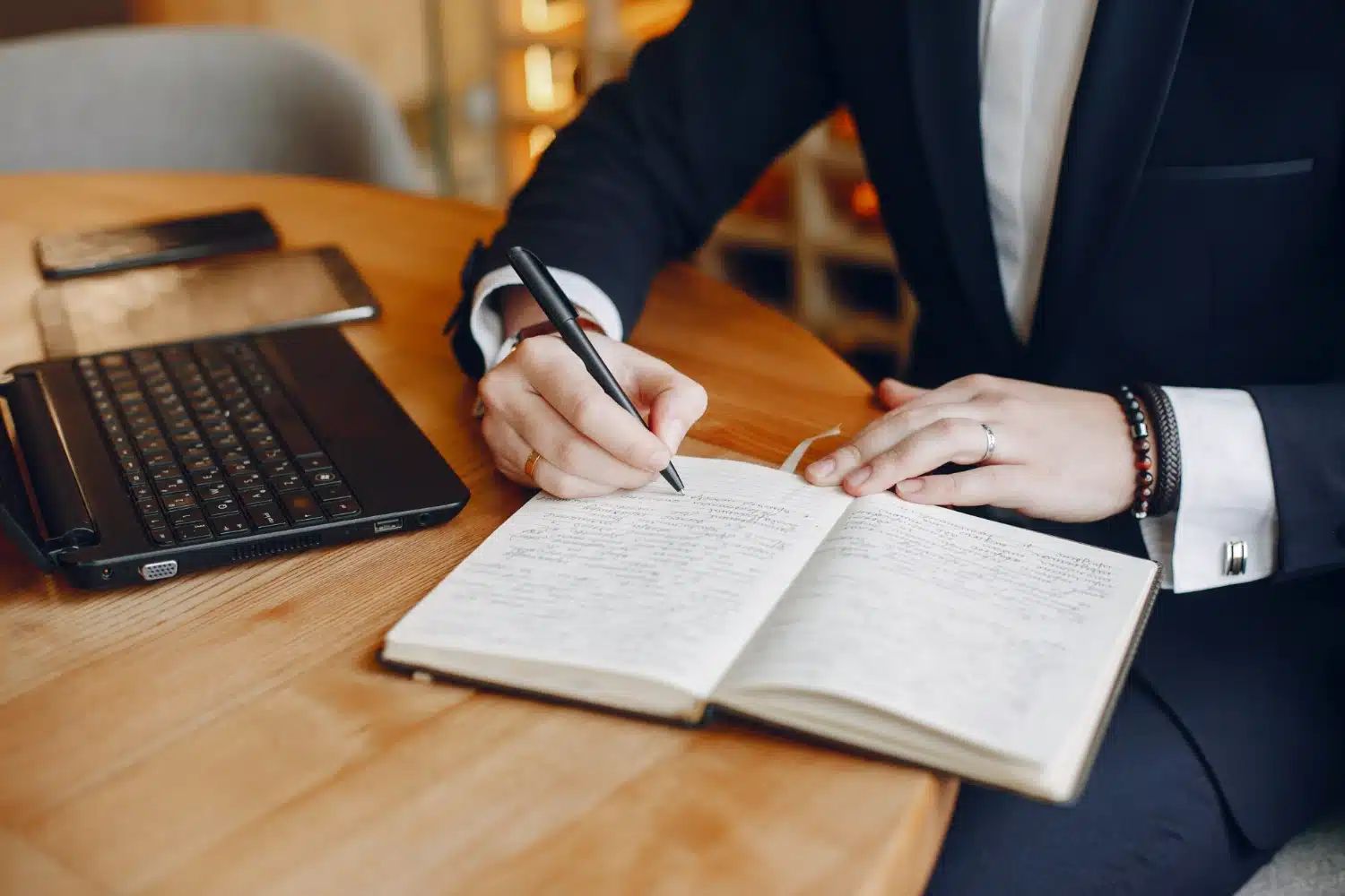 a lady writing on notebook and working for law firm as a content writer